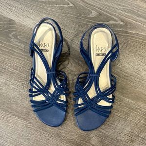 Dark blue, slightly heeled shoes with cris crossing elastic on top.
